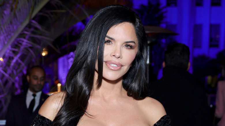 Lauren Sanchez Bezos smiling in a black dress at the Vanity Fair Oscar party.