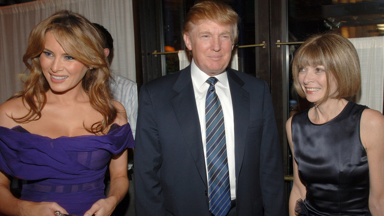Anna Wintour standing beside Melania and Donald Trump