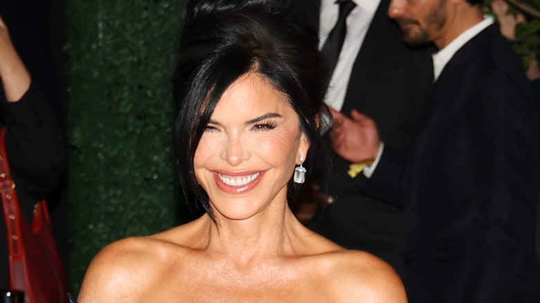 Lauren Sanchez smiling in a black dress while posing in New York City.