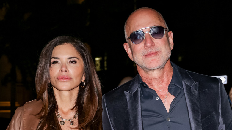 Lauren Sánchez Bezos and Jeff Bezos mug for the camera