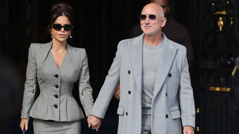 Jeff Bezos and Lauren Sánchez-Bezos walking while holding hands