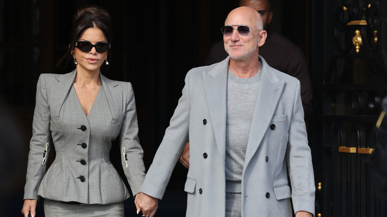 Lauren Sánchez and Jeff Bezos wearing coordinating gray outfits