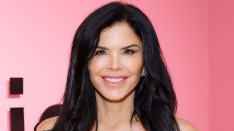 Lauren Sanchez smiling in a white dress while attending the Skirball Cultural Center.
