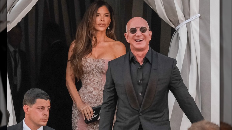 Lauren Sanchez looking thoughtful while Jeff Bezos laughs