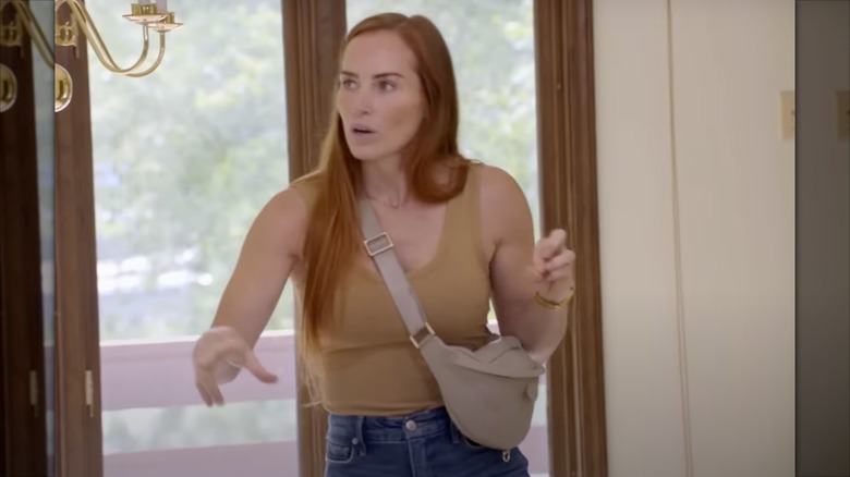 Mina Starsiak Hawk wearing a designer bum bag while touring a house