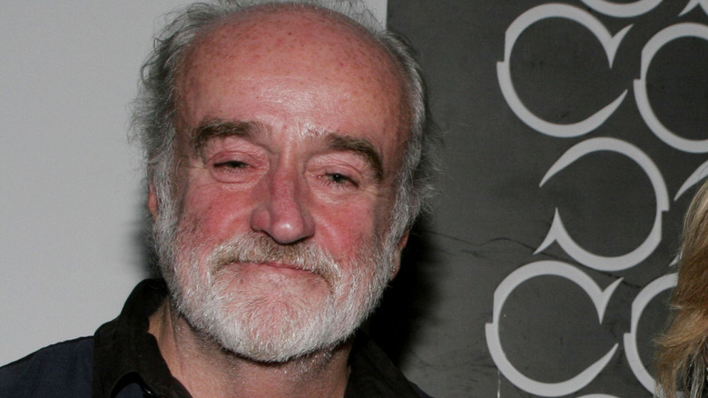 Ron McLarty on a red carpet with his wife and a friend