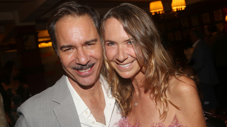 Janet Holden smiles alongside Eric McCormack