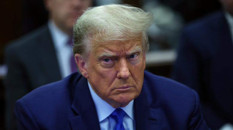 A somber Trump seated in courtroom