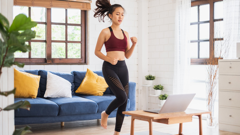 Woman jogging in place at home