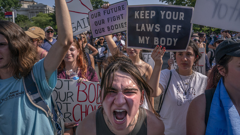 protestors holding up signs