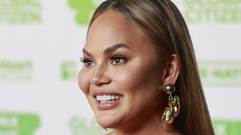 Chrissy Teigen wears orange