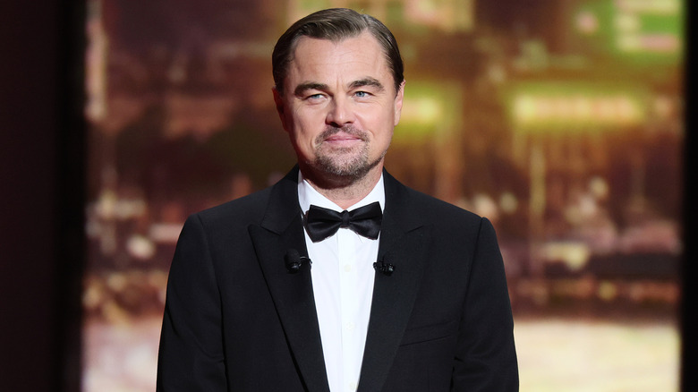 Leonardo DiCaprio smiling in a black tuxedo