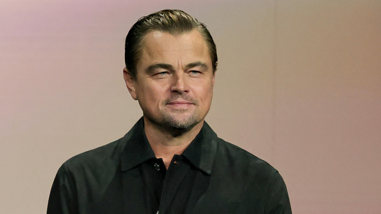 Leonardo DiCaprio smiling in a black dress shirt
