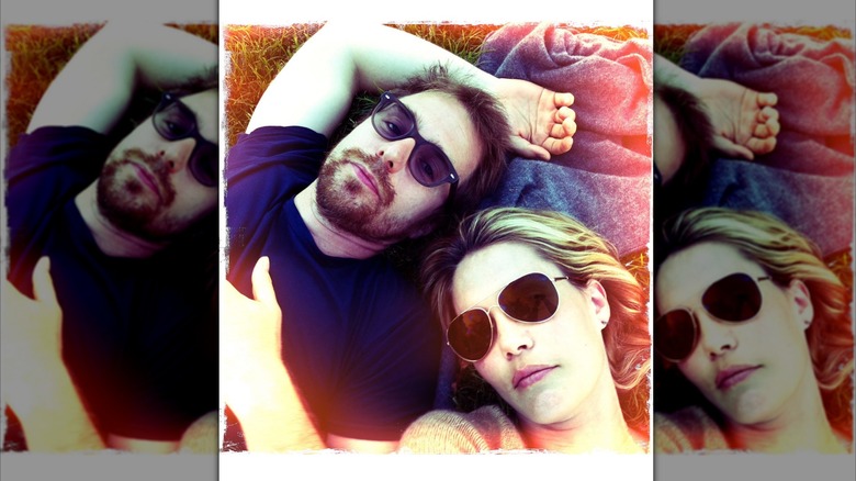 Leslie Bibb and Sam Rockwell lying down wearing sunglsses in early selfie in Ireland