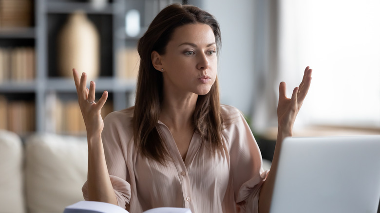 angry woman looking at laptop