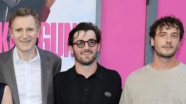 Liam Neeson posing with his sons at the Naked Gun premiere