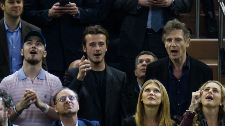 Liam Neeson with his sons at a hockey game