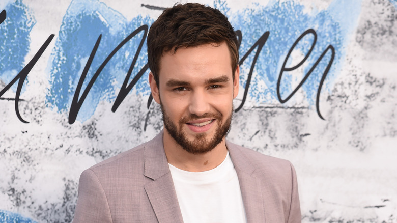 Liam Payne smiling while arriving at a party