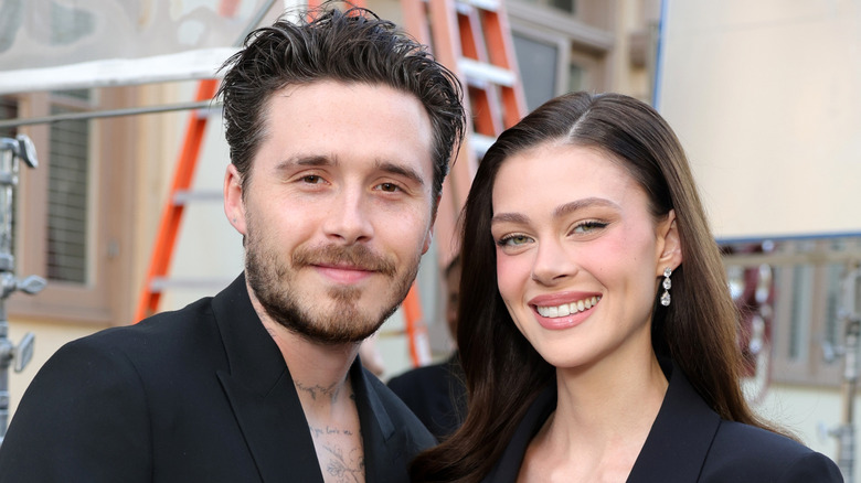 Brooklyn Beckham and Nicola Peltz smiling