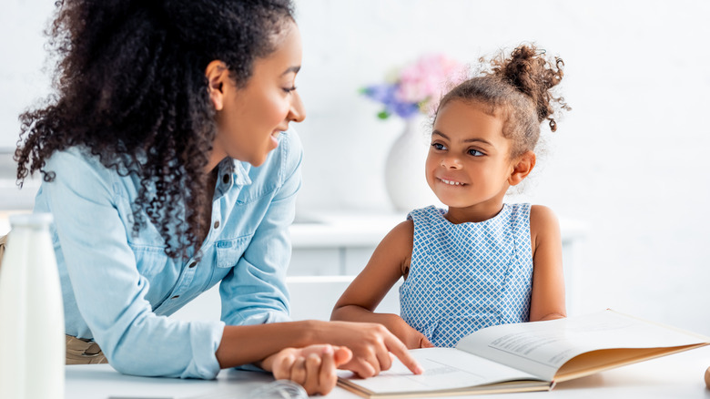 A mother and child with a book