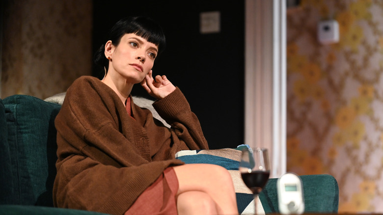 Lily Allen performing on stage for the play "2:22: A Ghost Story" in 2021