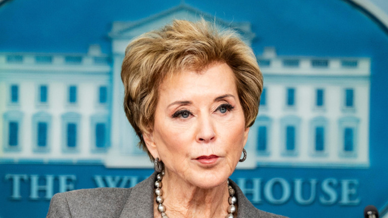 Linda McMahon at a podium in the White House with pursed lips