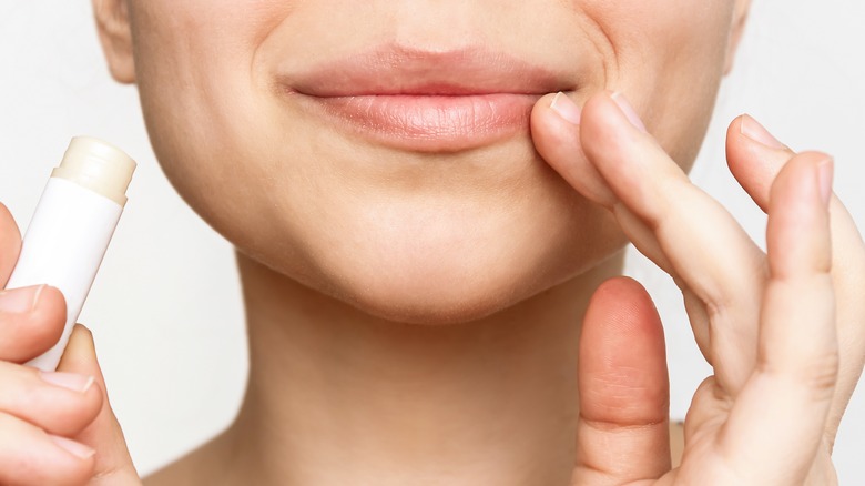 A woman touching her lip