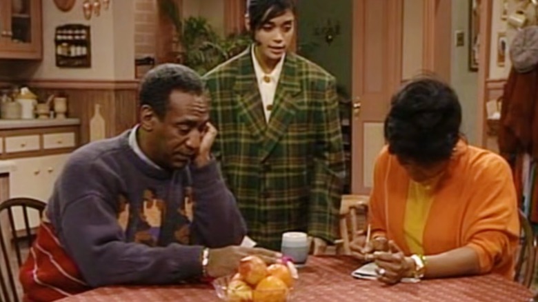 Lisa Bonet as Denise Huxtable in "The Cosby Show" standing between Bill Cosby and Phylicia Rashad as Cliff and Clair Huxtable