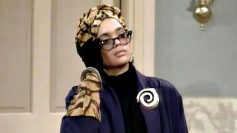 Lisa Bonet acting as Denise Huxtable in "The Cosby Show tilting her glasses