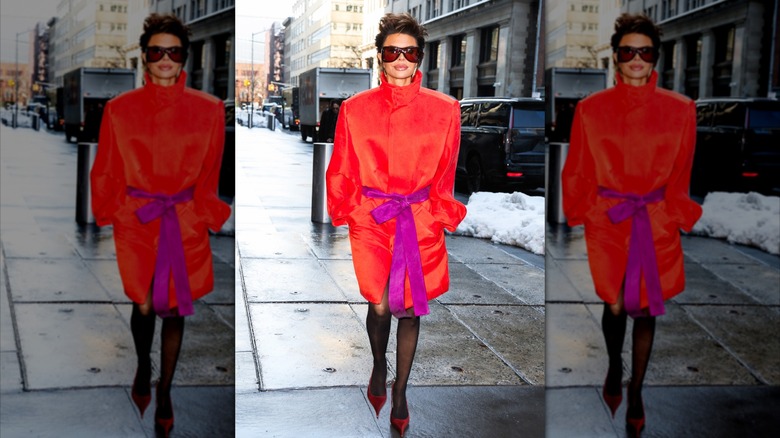Lisa Rinna in a neon orange outfit on a street in New York