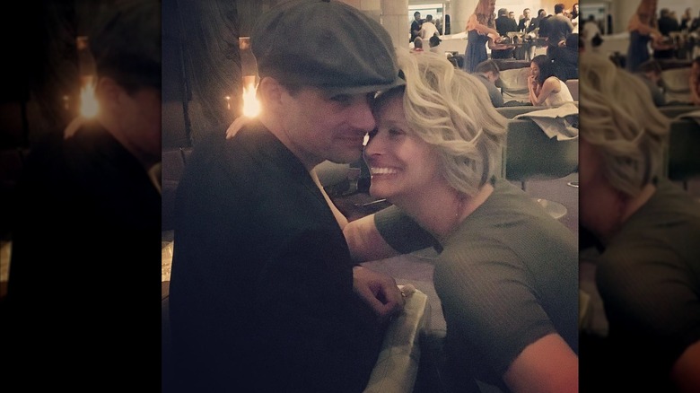 Warren and Sonya Christie sitting at a table embracing in 2017