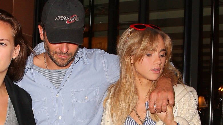 Bradley Cooper holding Suki Waterhouse's hand