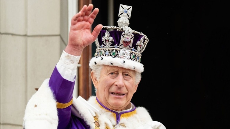 King Charles III waving crown