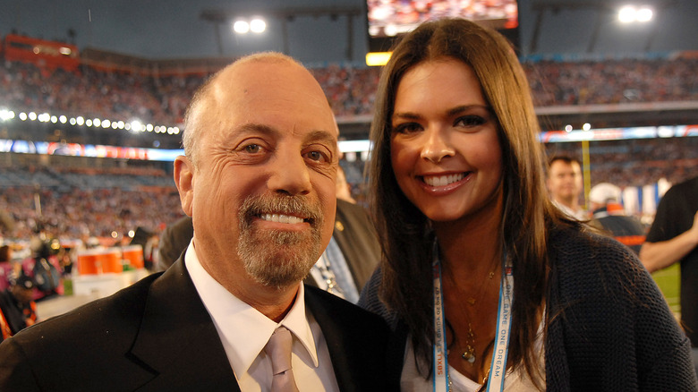 Billy Joel and Katie Lee posing for photos
