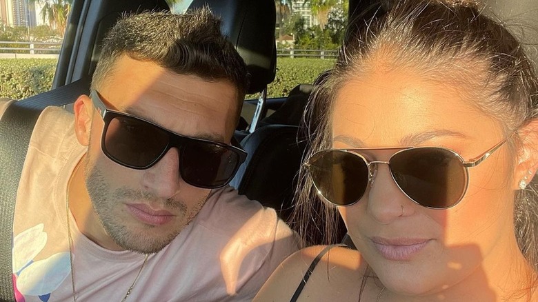 Loren and Alexei Brovarnik taking a selfie in a car