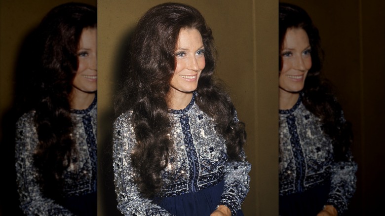 Loretta Lynn in a blue dress with a beaded vest top