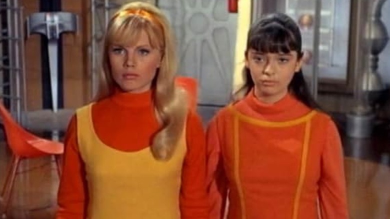 Marta Kristen as Judy Robinson and Angela Cartwright as Penny Robinson on Lost in Space