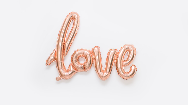 Rose gold foil balloon spelling out the word love