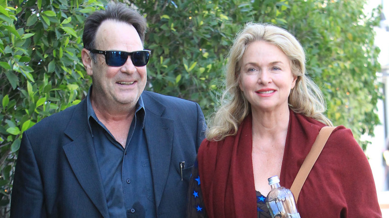 Dan Aykroyd and Donna Dixon walking together