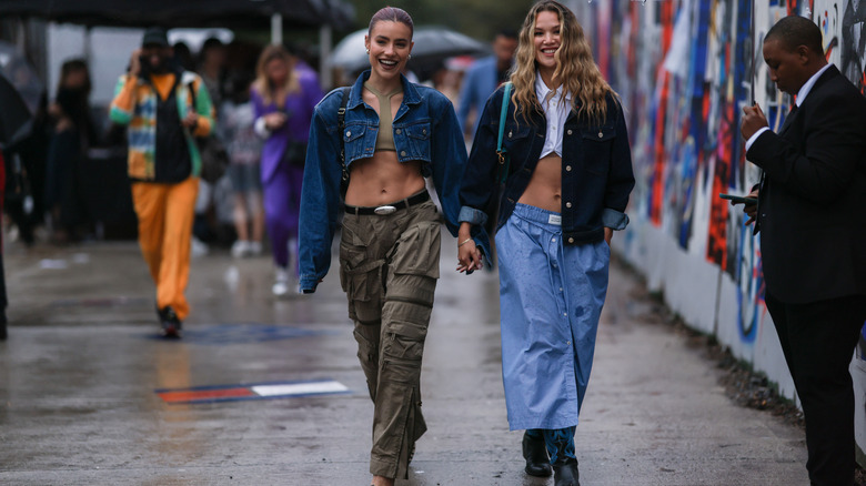 Two women holding hands laughing