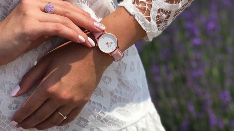 hand adjusting pink watch