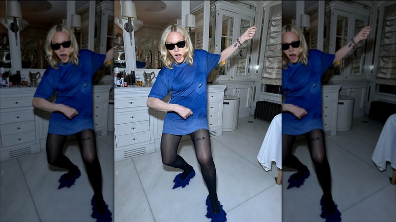 Madonna wearing sunglasses in her home bathroom