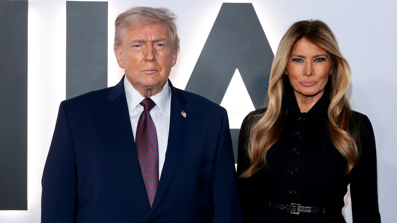 Donald and Melania Trump staring into camera at movie premiere