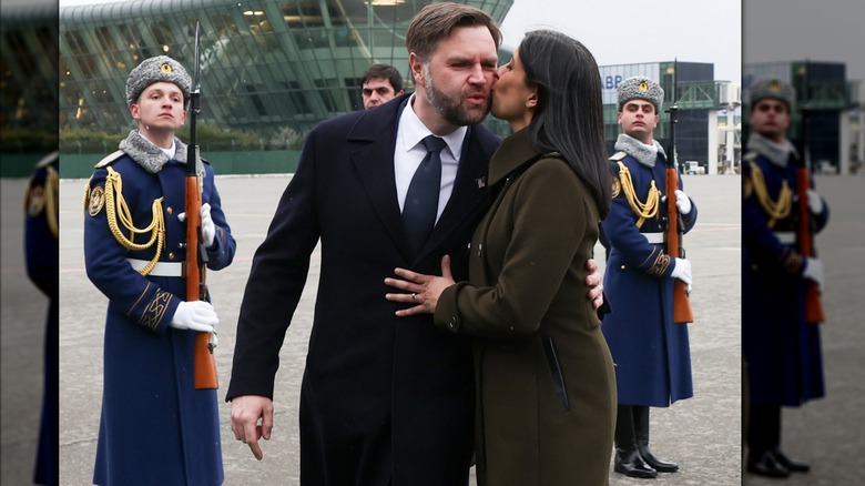 Usha Vance kissing JD on cheek with guards watching