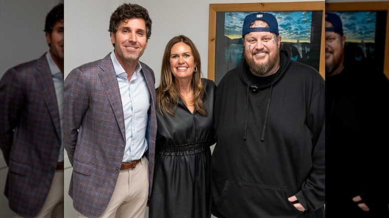 Bryan Chatfield Sanders, Sarah Huckabee Sanders, and Jelly Roll pose together in 2024