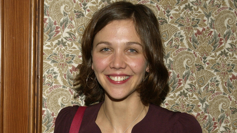 Maggie Gyllenhaal smiling at an event in 2002