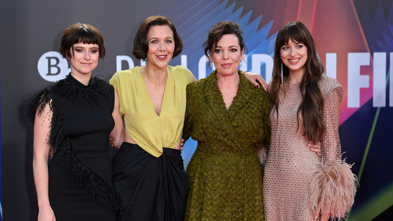 Jessie Buckley, Maggie Gyllenhaal, Olivia Coleman, and Dakota Johnson walking the red carpet.