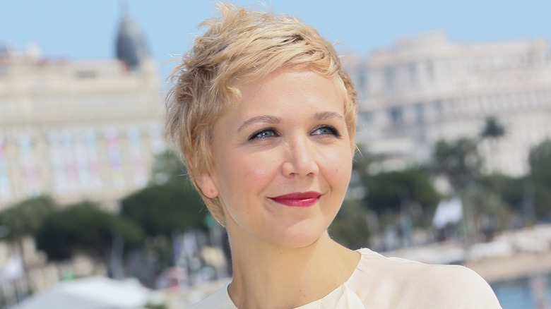 Maggie Gyllenhaal with short, blonde hair at Cannes in 2014.