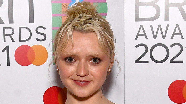 Maisie Williams smiling with new blonde hair and eyebrows