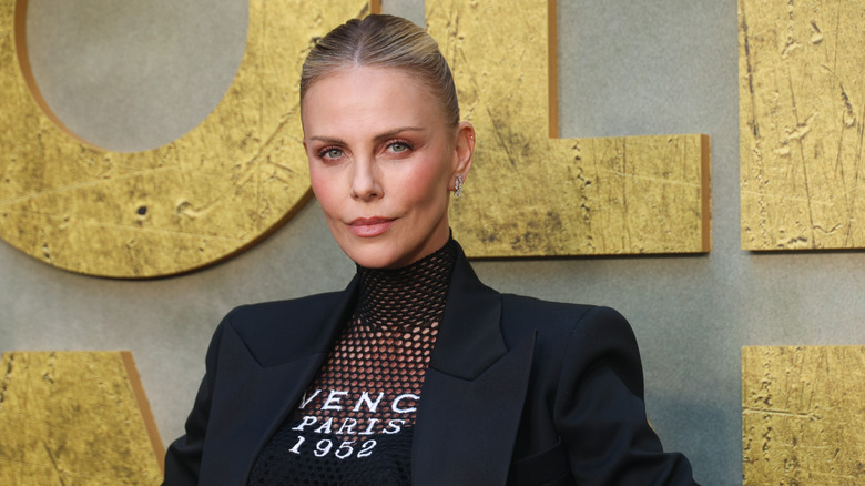 Charlize Theron in a mesh top and black blazer